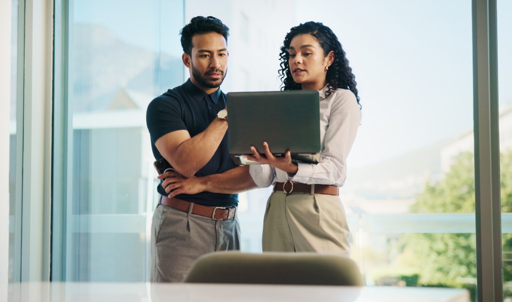 Business people, laptop and meeting with real estate team, discussion or available listings on website. Check, collaboration and property review for realtor group, strategy or client feedback on pc.